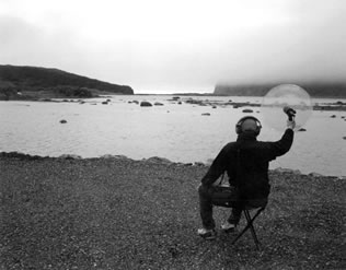 Artist in St. Anthony, Newfoundland, recording sound with a parabolic disc
